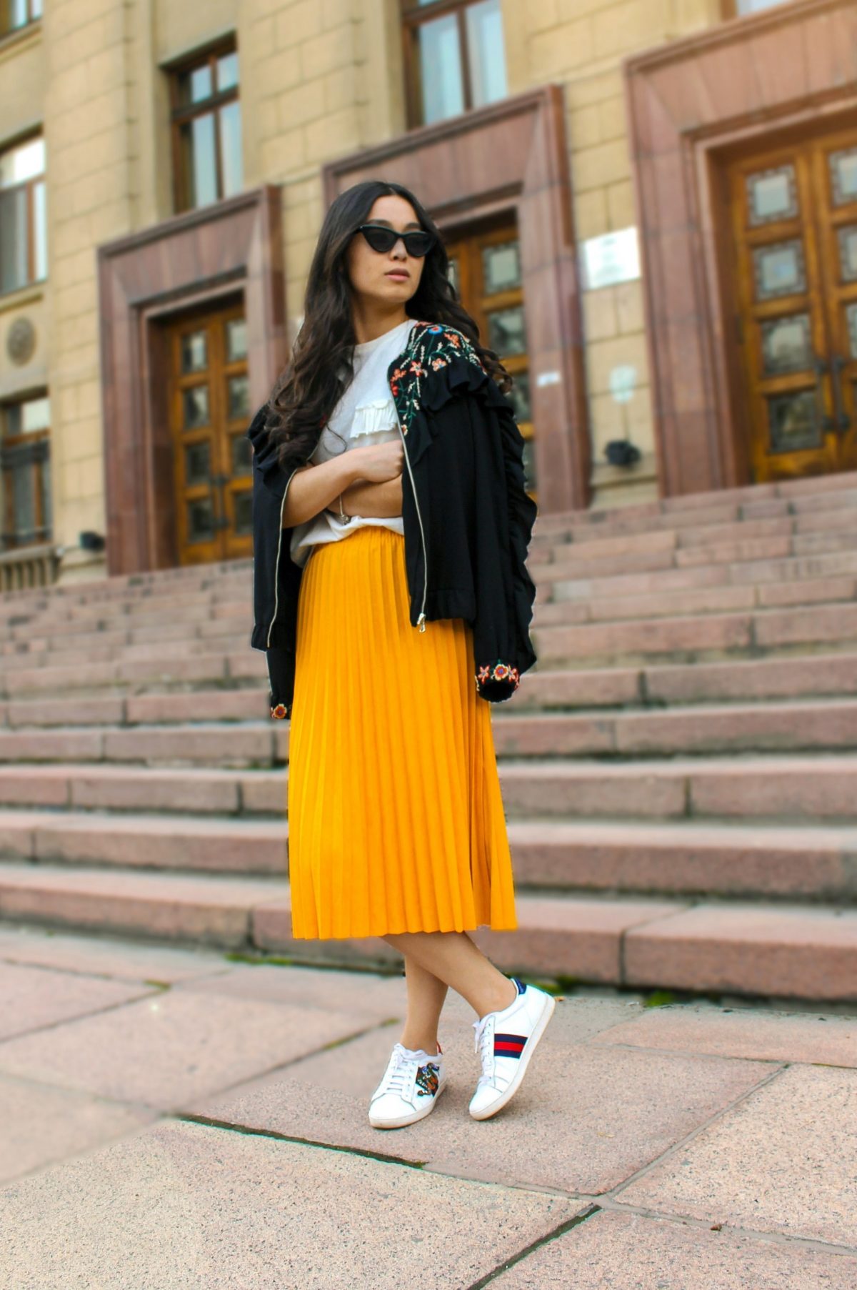 pleated skirt with trainers and jacket outfit casual style