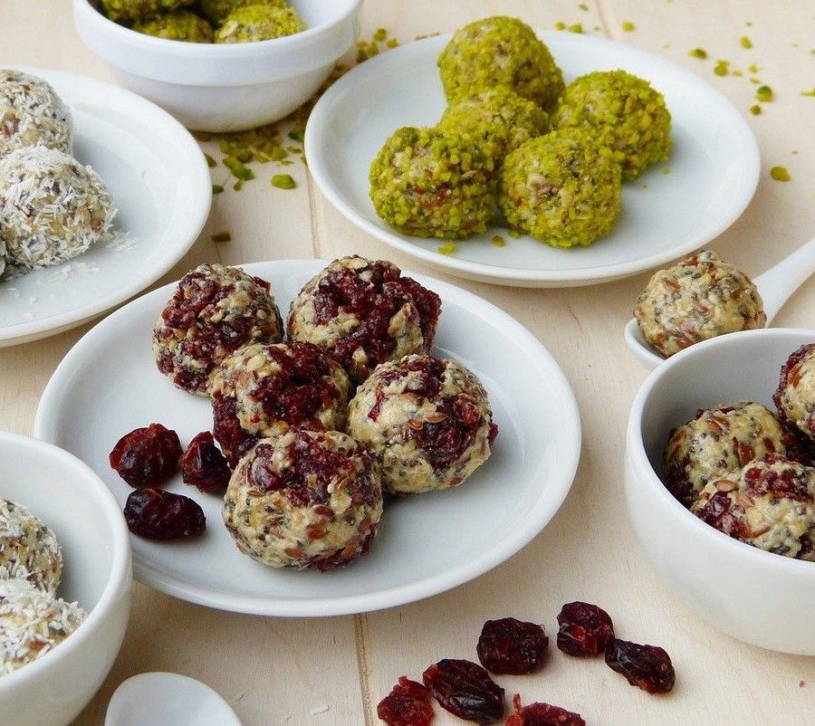 energy balls with different ingredients cranberries coconut oats pistachios flaxseed