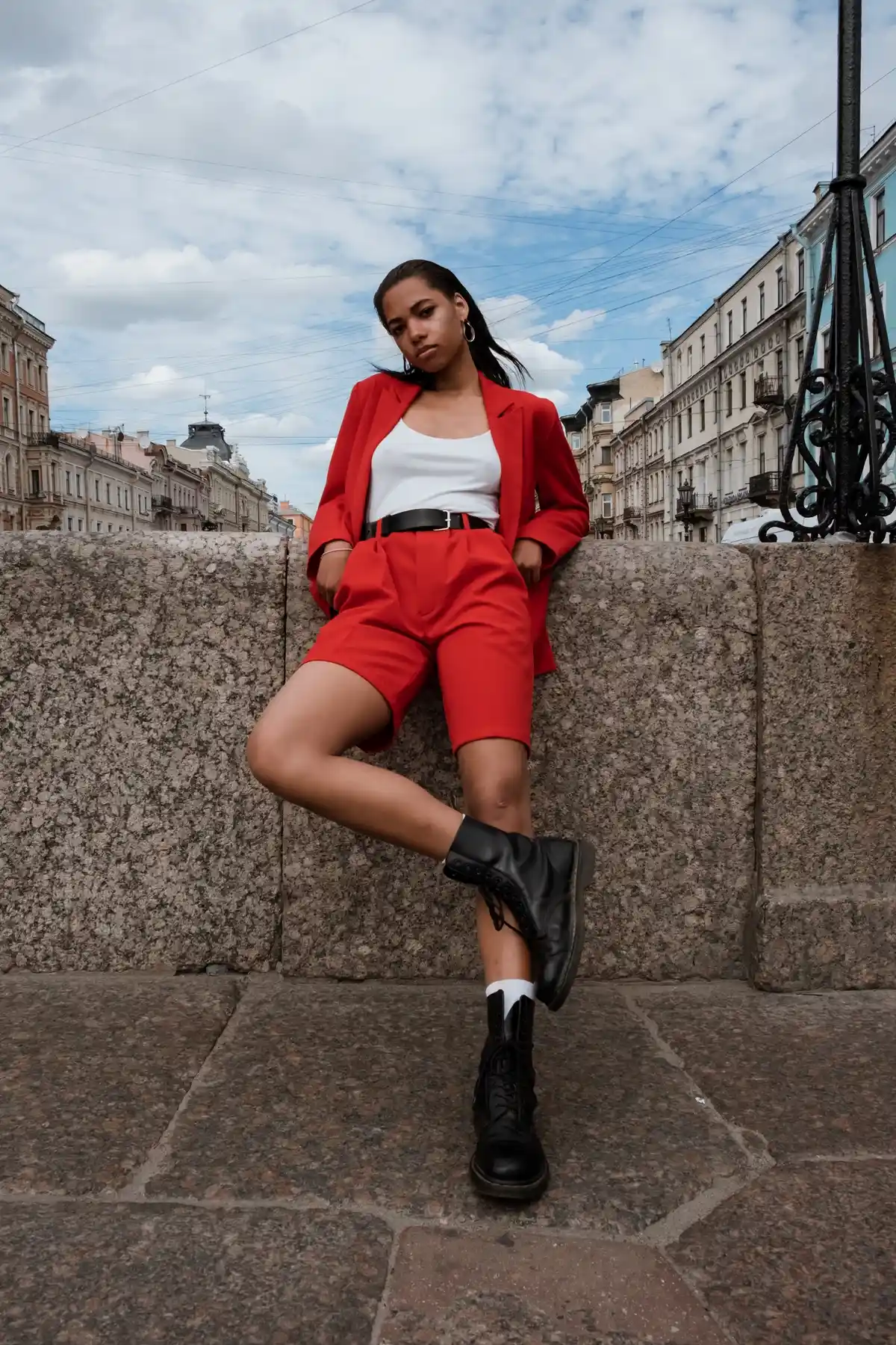 outfit with black ankle boots red suit and white top