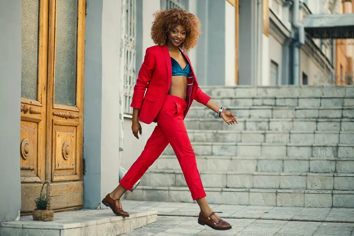 red suit with brown loafers and blue velvet bra top