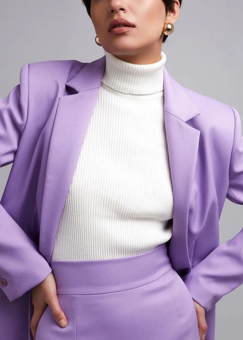 lilac suit paired with white turtleneck
