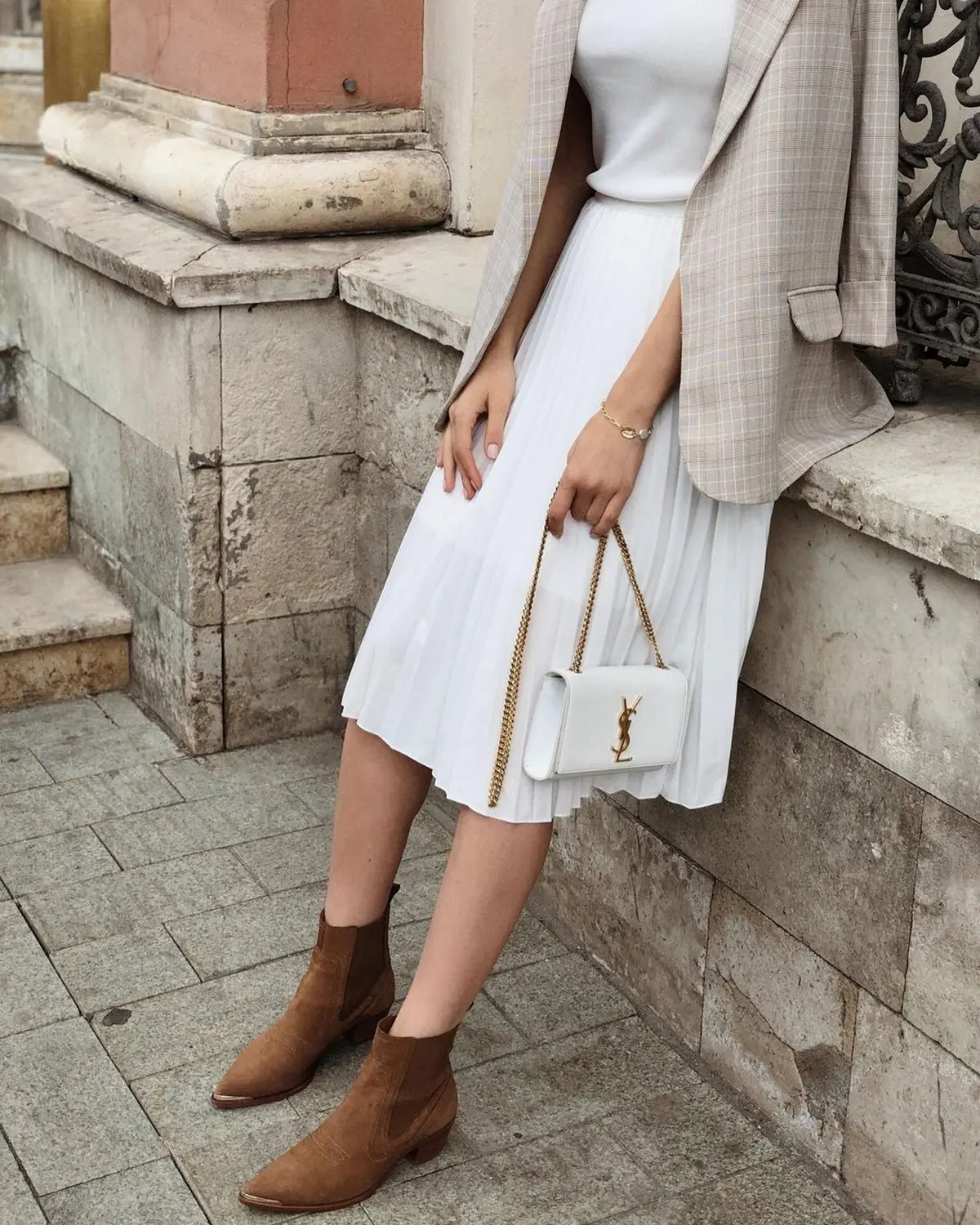 work outfit with white midi pleated skirt suede boots and beige blazer