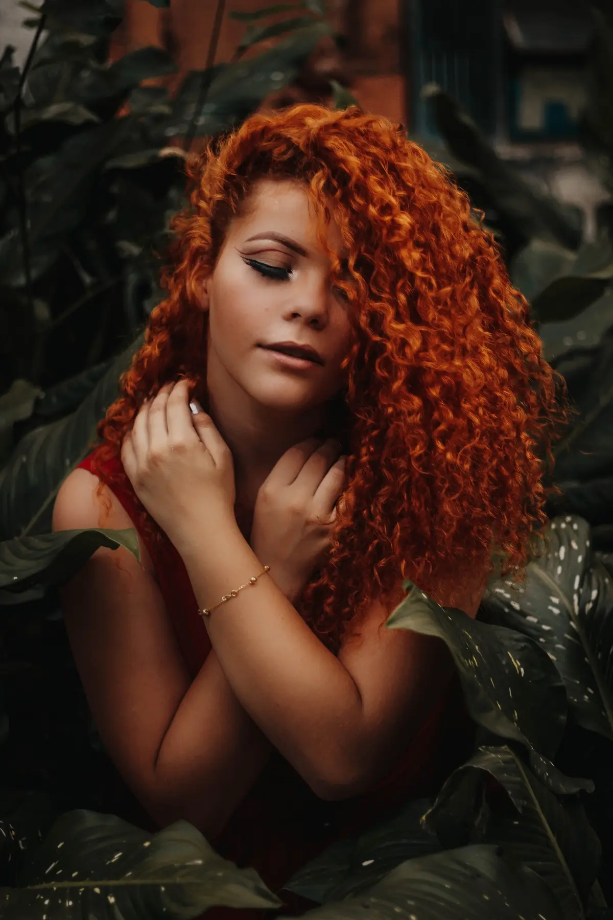auburn red curly hair and warm olive skin