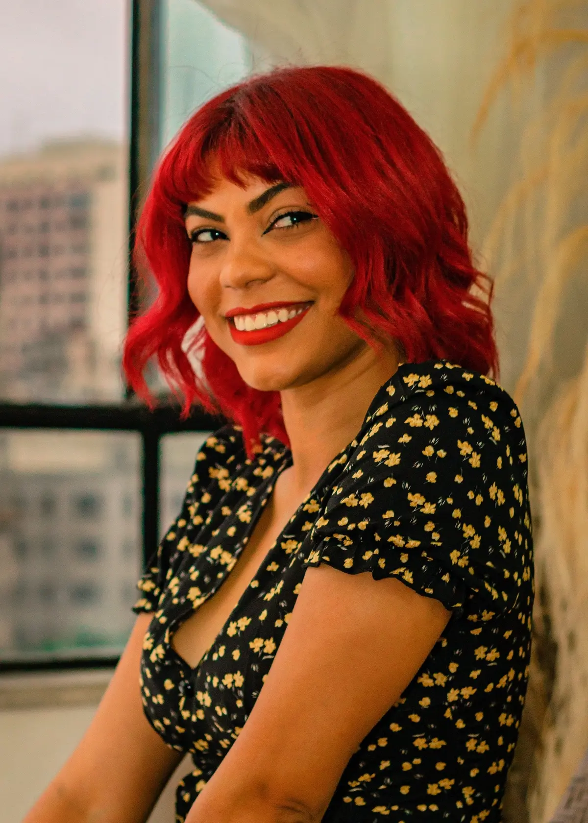 bright cherry red hair on woman with warm olive skin and brown eyes