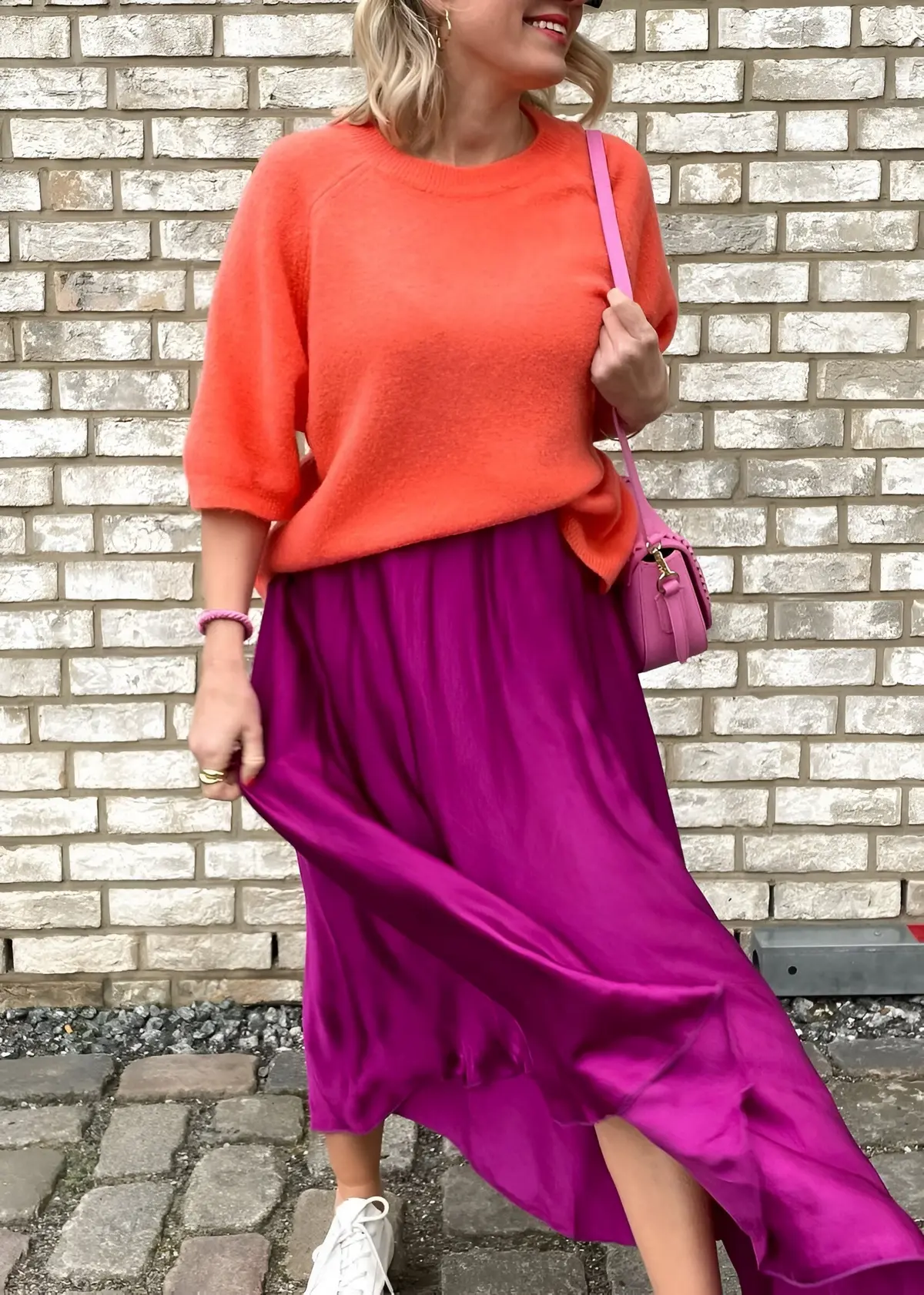 plum purple skirt outfit for spring with orange sweater and white sneakers