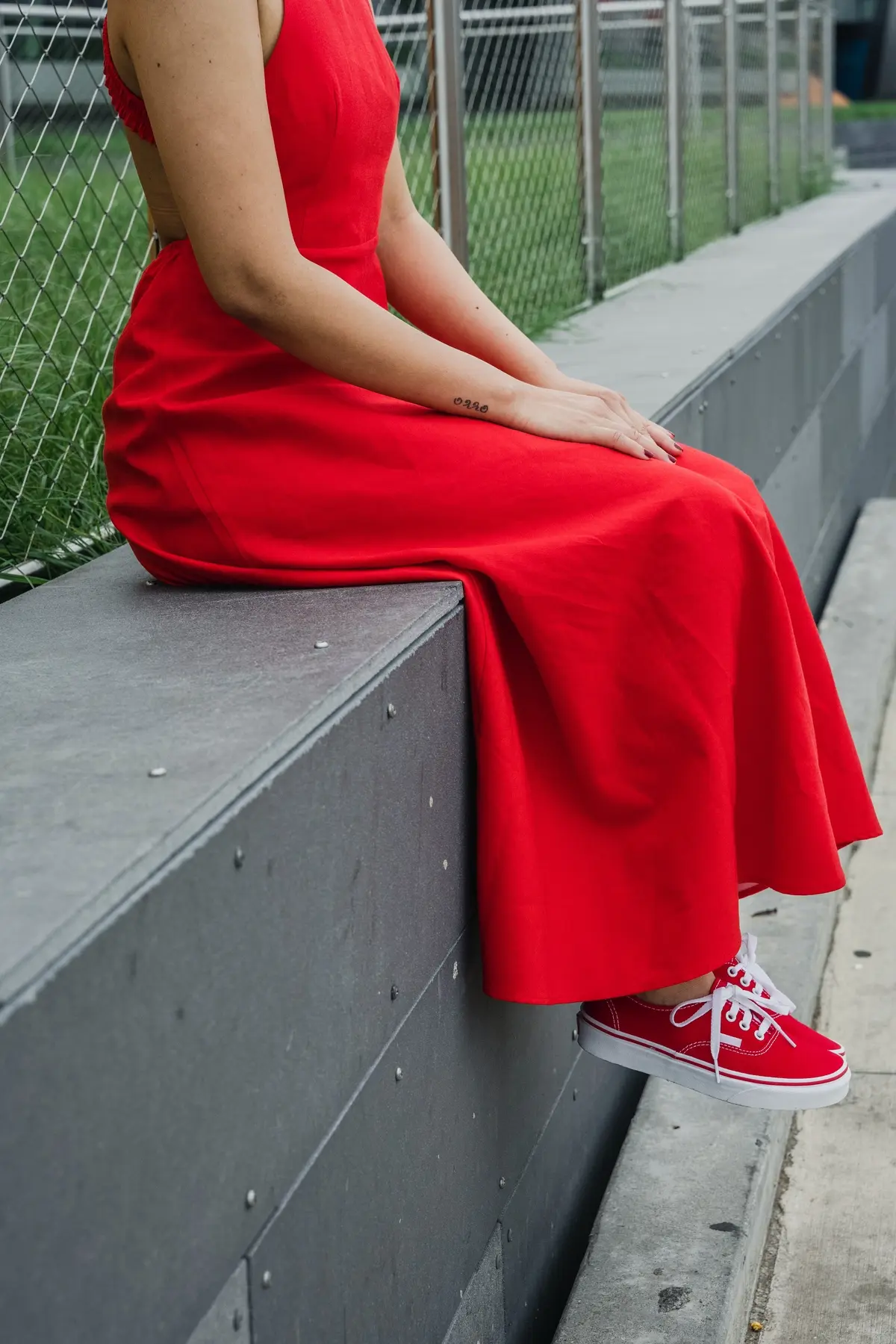 red cotton maxi halter dress paired with canvas shoes in the same color