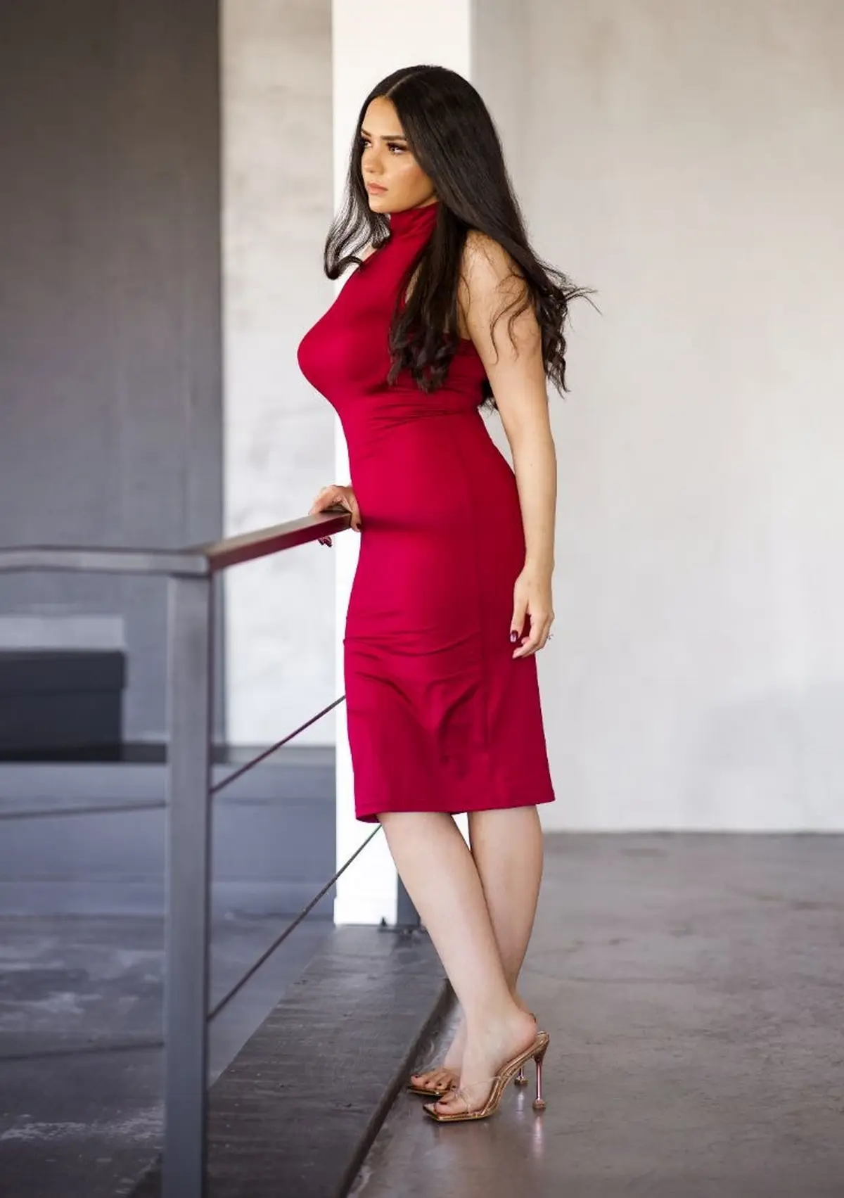 red midi neckholder dress paired with gold sandals