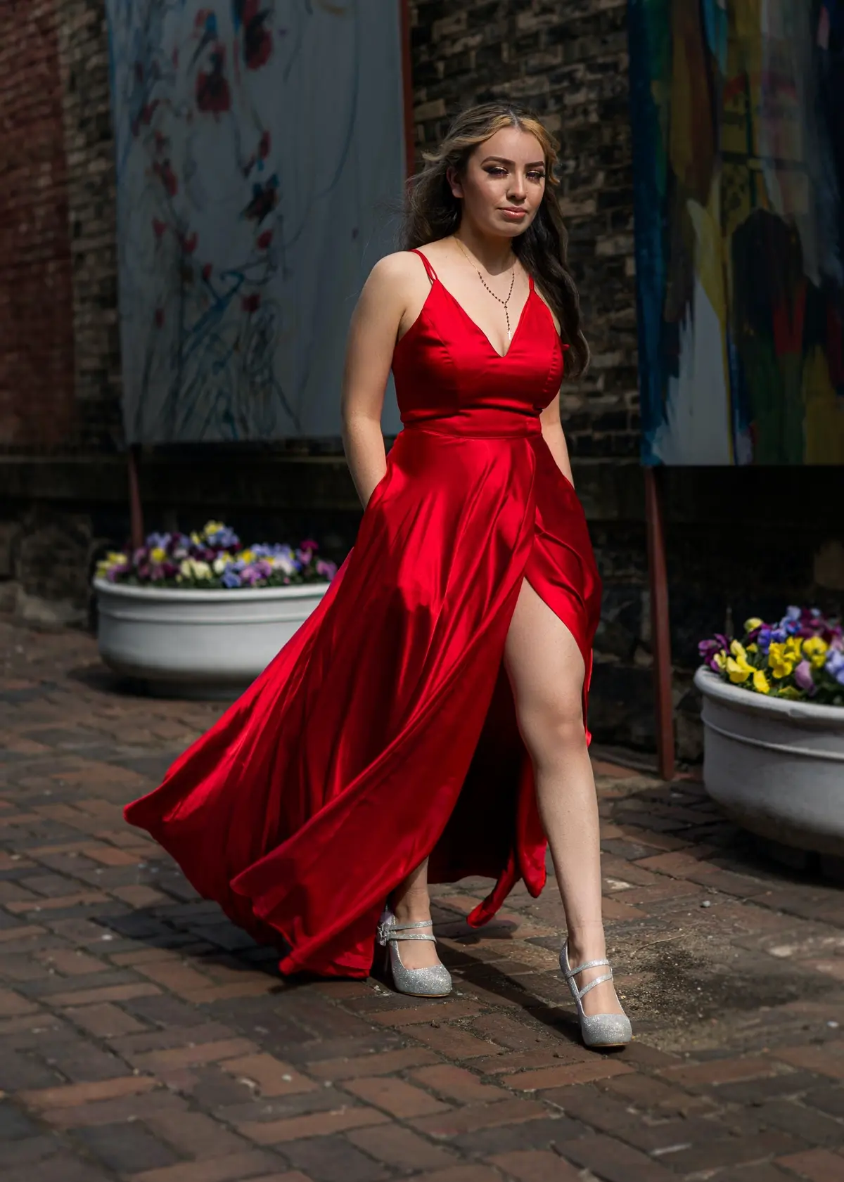 red satin evening dress paired with silver pumps