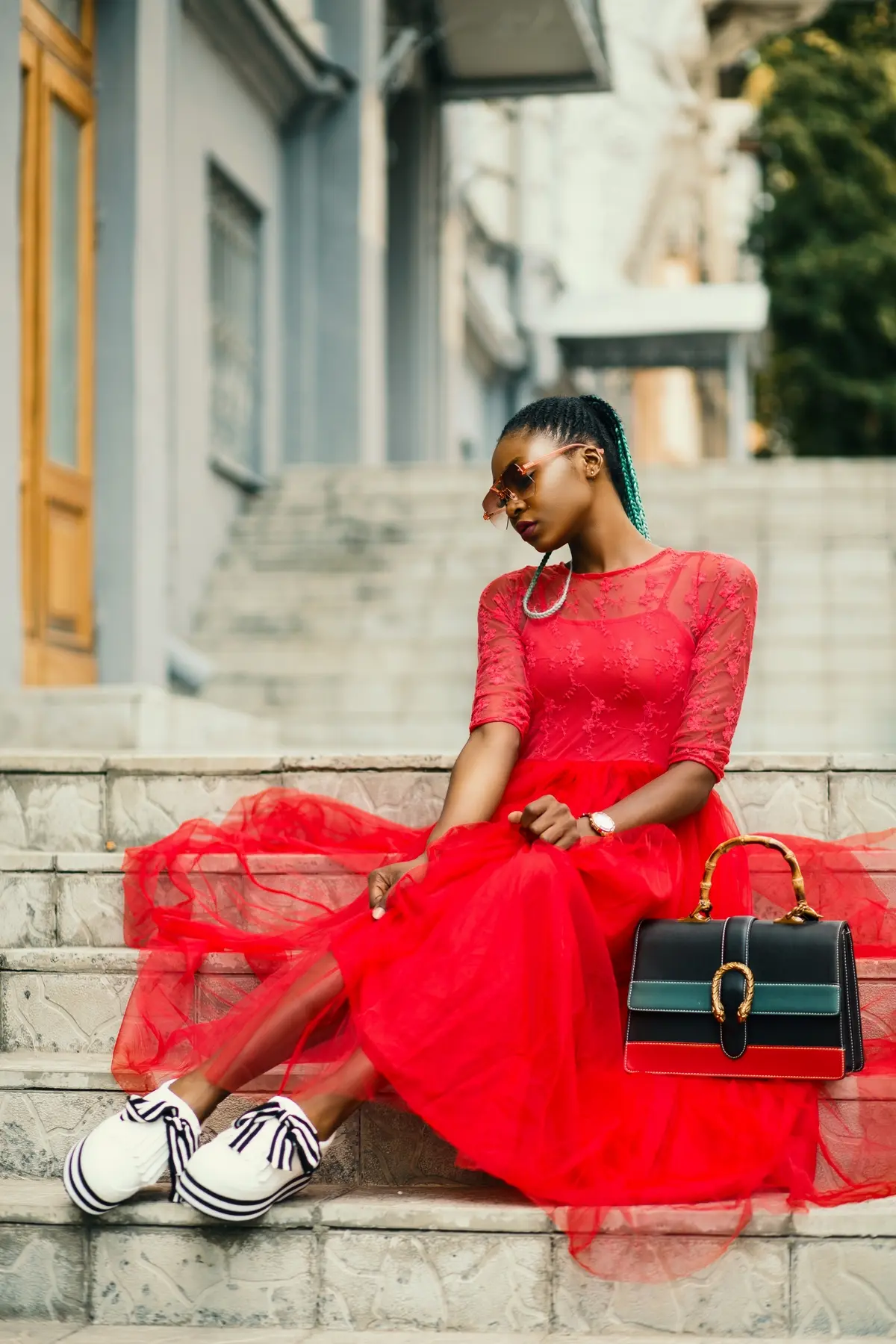 red tulle dress paired with black and white sneakers