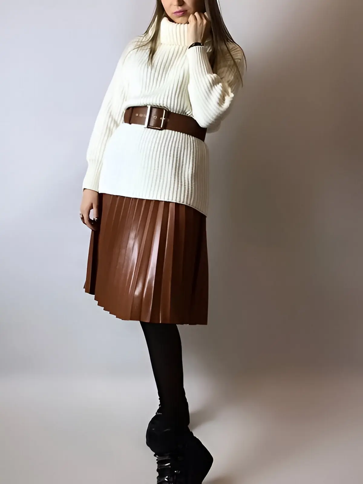 brown leather pleated skirt paired with cream sweater and belt