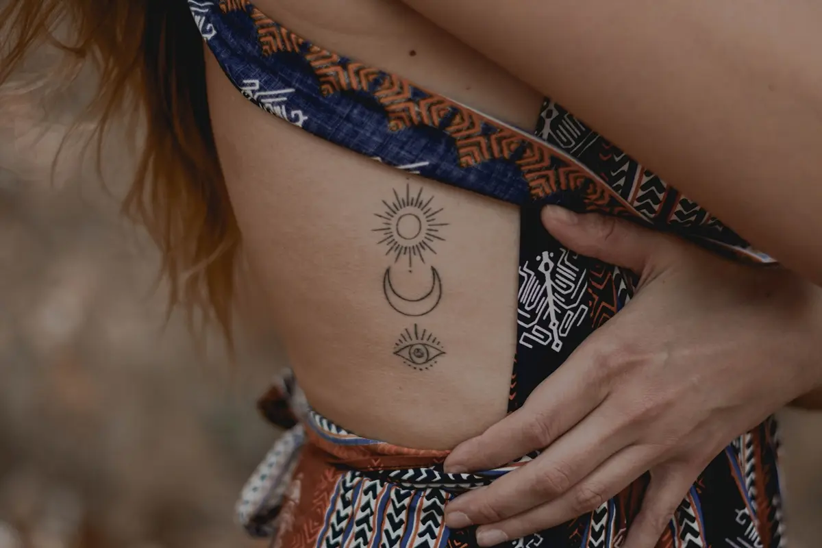 moon sun and eye tattoo on ribs