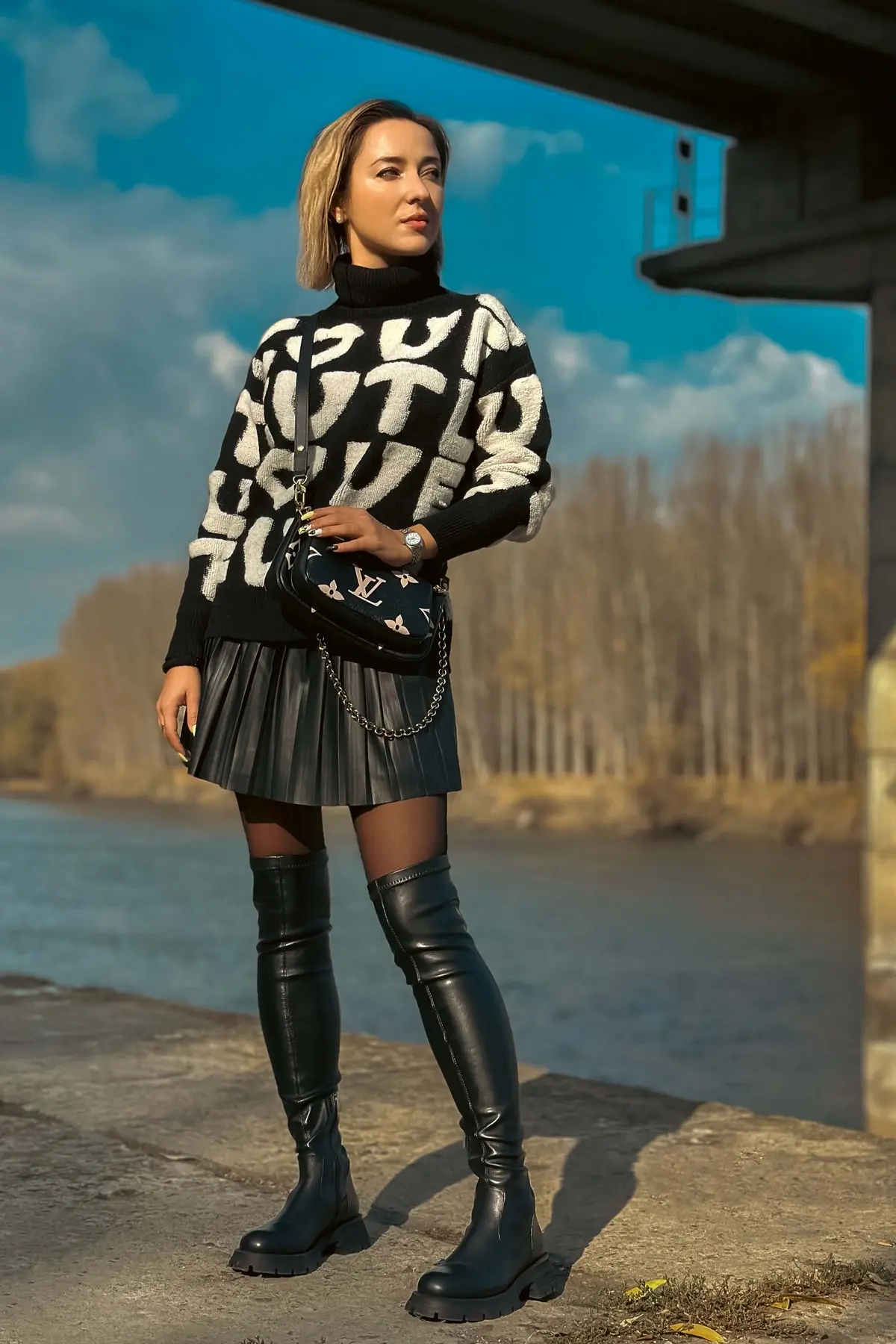 over the knee black leather boots for skinny legs paired with short pleated skirt and sweater