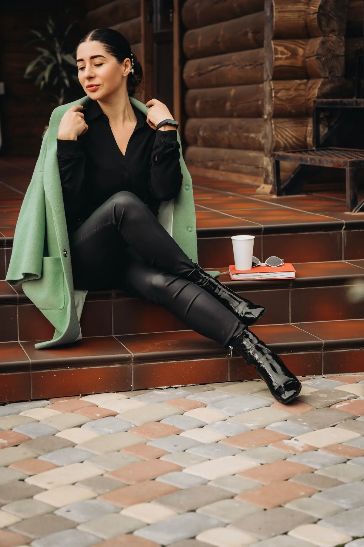 shiny ankle boots black leggings and green coat
