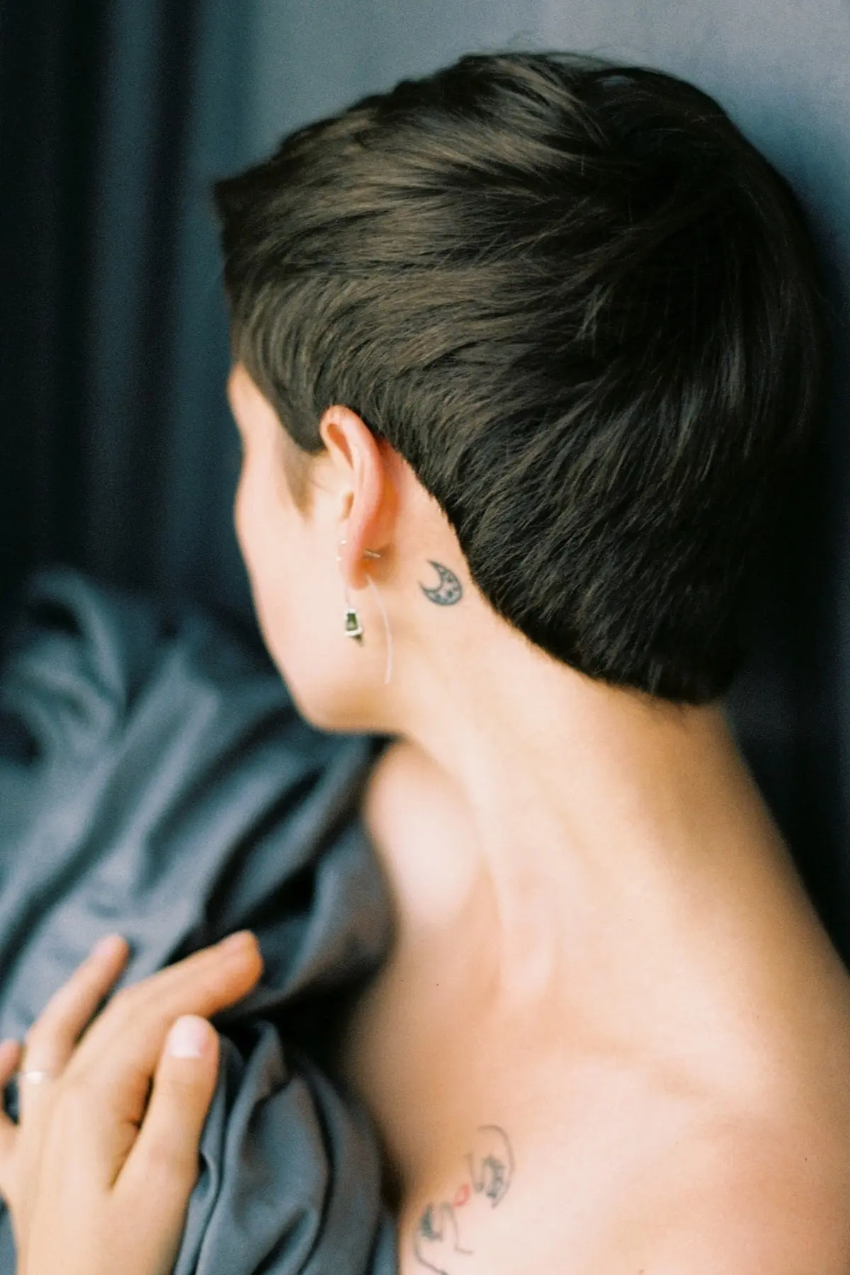 small half moon tattoo behind ear