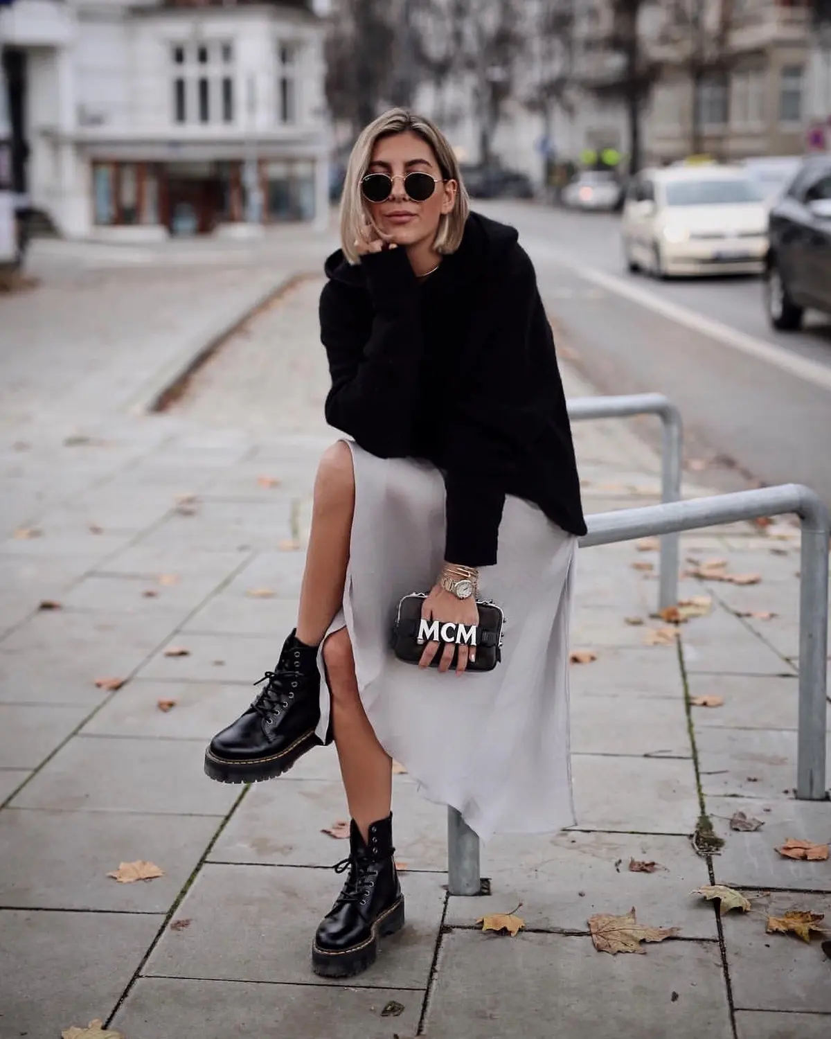 silver satin skirt and black sweater with combat boots