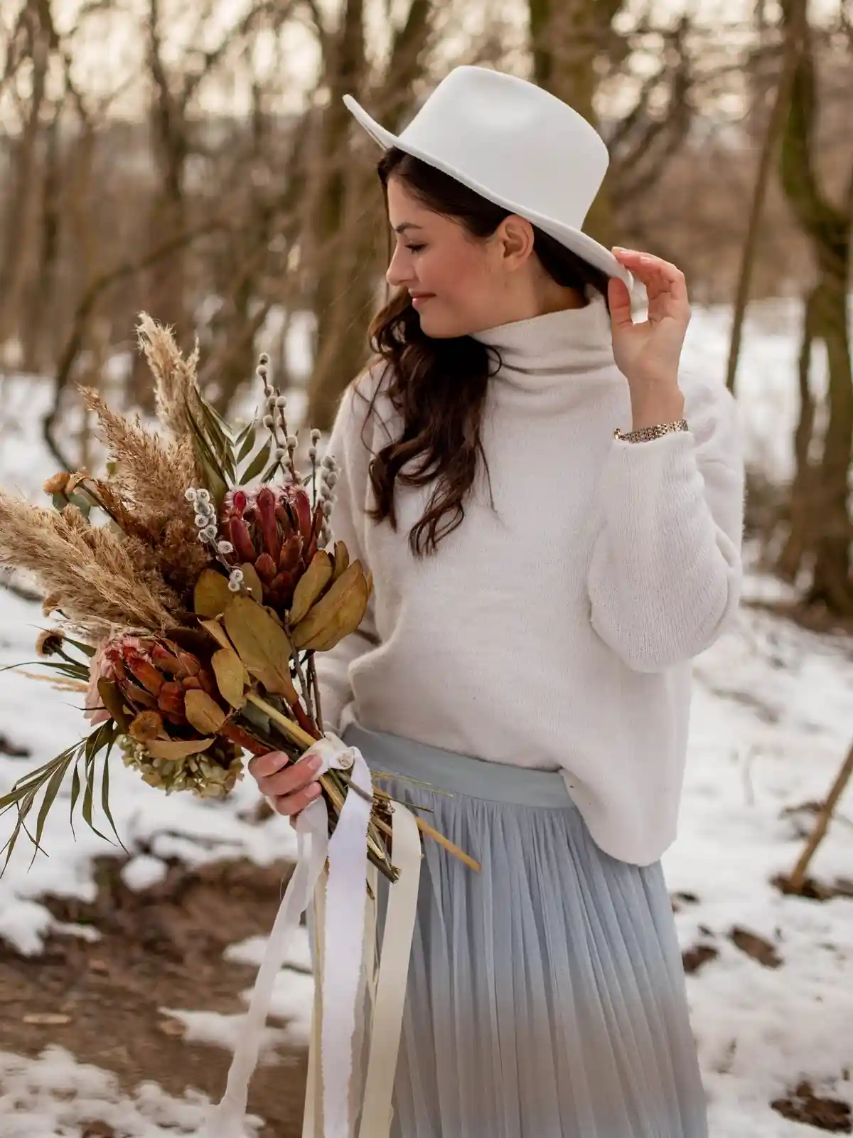 light grey tulle skirt paired with white sweater and fedora hat