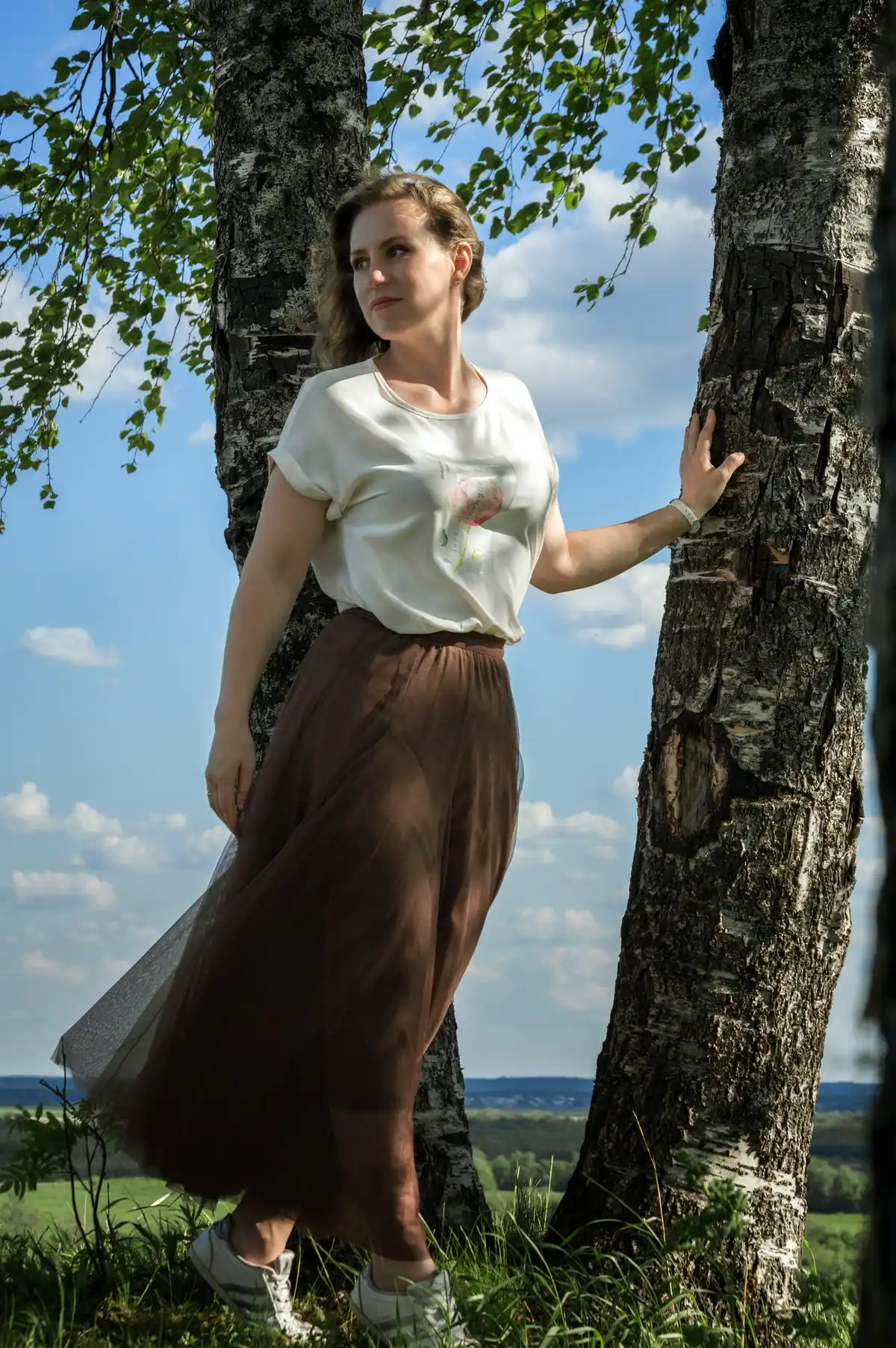 long tulle skirt paired with satin blouse and sneakers