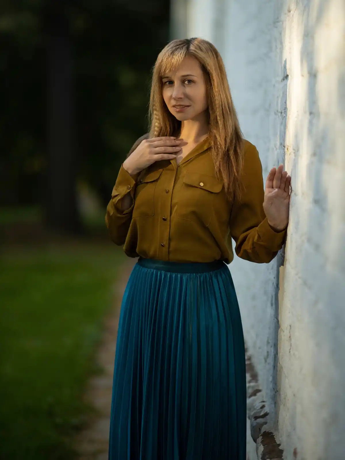 pleated emerald skirt paired with khaki shirt