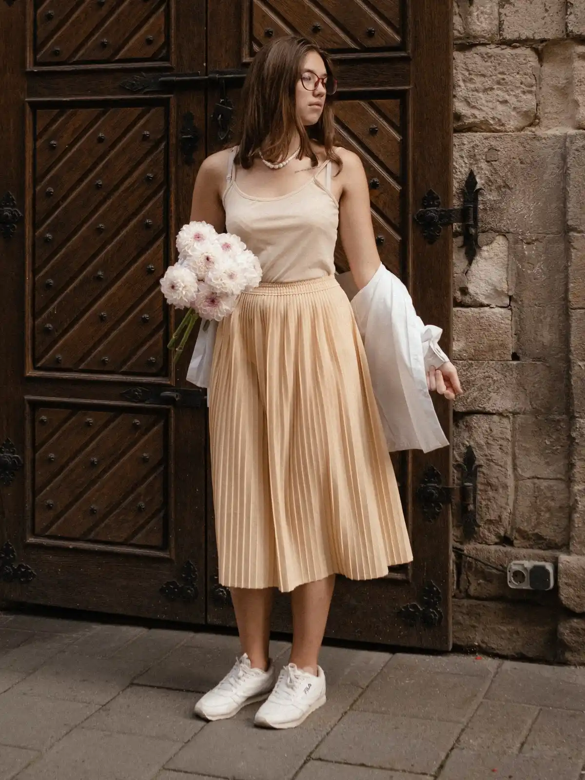 pleated tulle skirt paired with sneakers and nude top