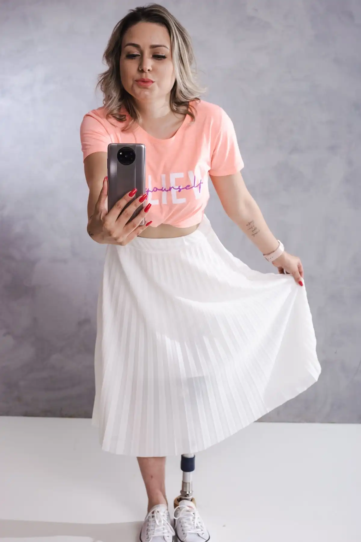 white pleated skirt paired with apricot t-shirt